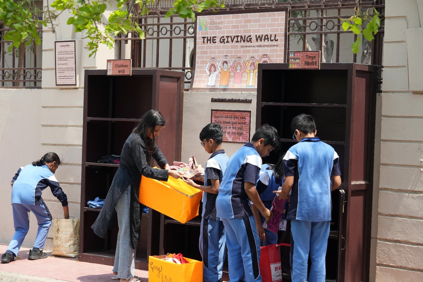 The Giving Wall — middle school students sorting donated clothes and toys for the community