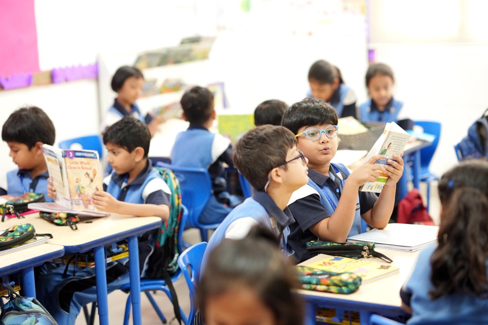 Junior students reading together in the class library